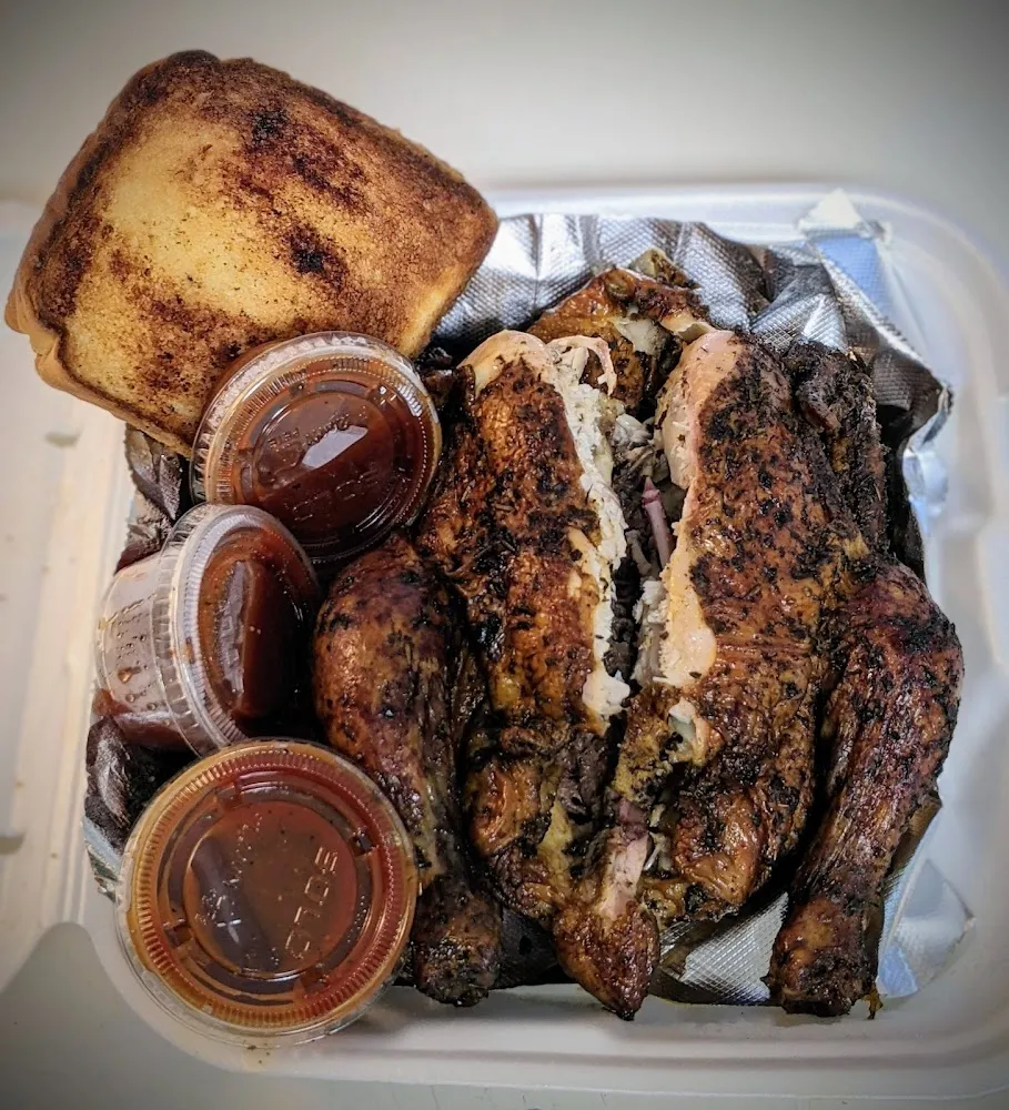 A Whole Smoked Chicken with Sauce and a Piece of Bread